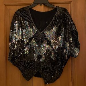 Sequined black. Paillettes and pearls catch the light for a stunning effect.